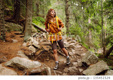 Young woman with backpack traveling outdoors. Hiking, active lifestyle. Young woman with backpack traveling outdoors. Hiking, active lifestyle. 135451529