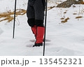 Hiker legs with crampons in snow 135452321