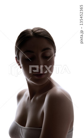 Low light female portrait with closed eyes and soft dramatic lighting. 135452365
