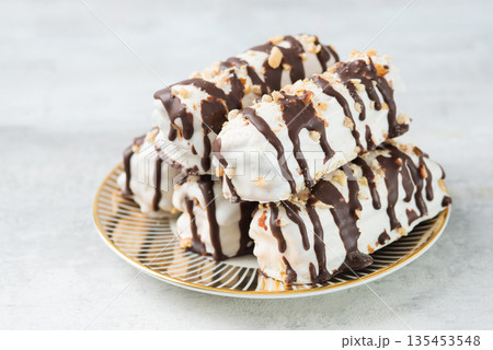 butter cookies dessert covered in chocolate and walnut glaze on gray table 135453548