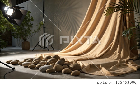 Studio scene with flowing tan curtain stones and professional lighting 135453906