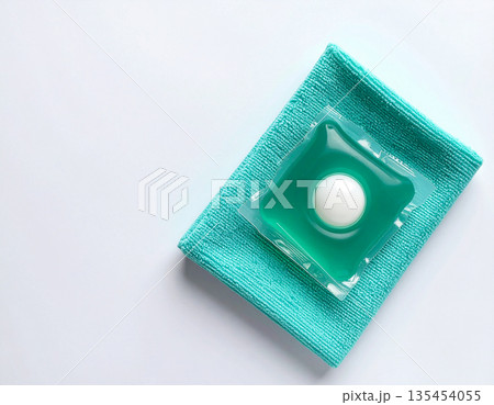 Hygiene concept. Soluble laundry detergent capsule on a neutral linen cloth with empty space for text. 135454055
