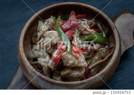Thai Spicy food, Spicy stir fried fish balls and thai herbs vegetables in wooden bowl. Thai Spicy food, Spicy stir fried fish balls and thai herbs vegetables in wooden bowl. 135454753