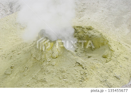 Fumarole fields on the slope of a volcano in the Kuril Islands, featuring surface openings emitting hot steam and yellow sulfur deposits. Fumarole fields on the slope of a volcano in the Kuril Islands, featuring surface openings emitting hot steam and yellow sulfur deposits. 135455677