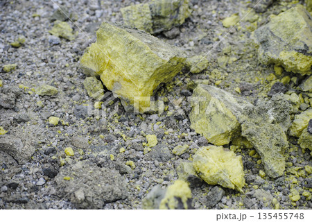 Macro shot of vibrant yellow sulfur crystals on a fumarole field. Natural mineral deposits on the slopes of Kuril Islands. 135455748