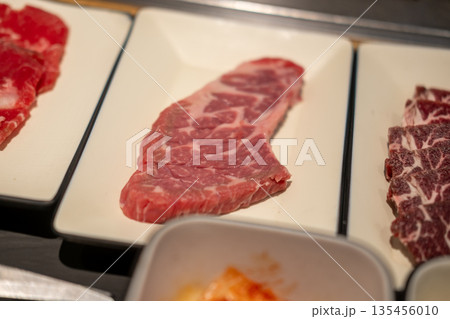 Korean Style Barbecue on plate. BBQ rare meat with soft focus 135456010