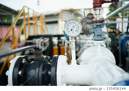 Pressure gauge on industrial pipeline with valve in factory. 135456144
