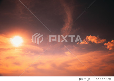 Dramatic Sunset Sky with Bright Sun and Glowing Clouds Dramatic Sunset Sky with Bright Sun and Glowing Clouds 135456226