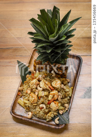 Thai chicken fried rice with pineapple and cashew on modrn bangkok restaurant table in thailand Thai chicken fried rice with pineapple and cashew on modrn bangkok restaurant table in thailand 135456669