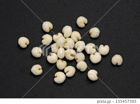 Puffed millet pile isolated on black background, cereal breakfast grains, top view, full depth of field 135457385