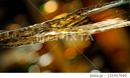 Pouring Whiskey from Bottle . Stream of Golden Liquid Flows on a Pub 135457680