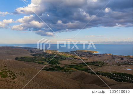 Scenic view of Issyk-Kul lake surrounded by mountains near Cholpon-Ata Scenic view of Issyk-Kul lake surrounded by mountains near Cholpon-Ata 135458050