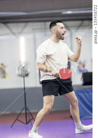 Male athlete celebrating table tennis victory Male athlete celebrating table tennis victory 135458722
