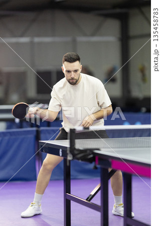 Young man playing table tennis racket sport activity Young man playing table tennis racket sport activity 135458783