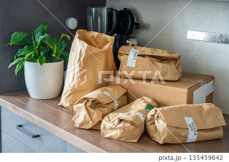 Meal kit ingredients sorted by recipe and placed on the kitchen counter. Concept of convenient grocery delivery for home cooking with pre-portioned ingredients. Meal kit ingredients sorted by recipe and placed on the kitchen counter. Concept of convenient grocery delivery for home cooking with pre-portioned ingredients. 135459642