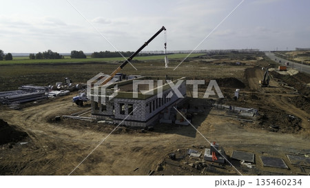 Construction crane lifting materials at building site. Clip Construction crane lifting materials at building site. Clip 135460234