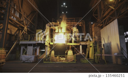 Molten metal pouring in steel plant at night. Stock clip 135460251