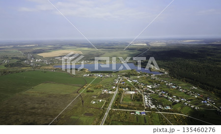 Autumn colors enhance russian countryside, showing serene lake and village. Clip 135460276