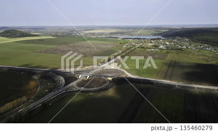 Highway interchange under construction connecting rural countryside. Clip 135460279