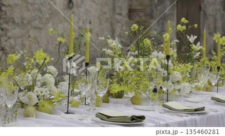 Elegant wedding table decorated with yellow flowers and lemons. Action Elegant wedding table decorated with yellow flowers and lemons. Action 135460281
