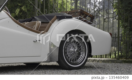 White triumph tr3 car parked in front of a gate. Action White triumph tr3 car parked in front of a gate. Action 135460409