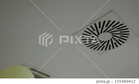 Balloons floating near air conditioning ceiling vents. Creative 135460412