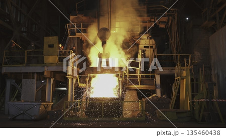 Molten metal pouring into container in steel mill. Stock clip Molten metal pouring into container in steel mill. Stock clip 135460438