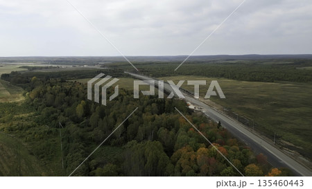 Highway construction expanding through autumnal forest landscape. Clip 135460443