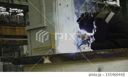 Industrial worker welding metal in factory. Stock clip Industrial worker welding metal in factory. Stock clip 135460448