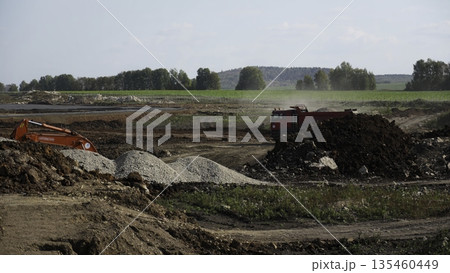 Excavator loading dump truck at construction site. Clip Excavator loading dump truck at construction site. Clip 135460449
