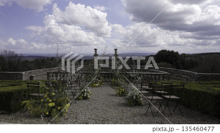Wedding ceremony location overlooking tuscan hills with floral decorations. Action 135460477