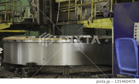 Large industrial lathe rotating and machining steel ring. Stock clip 135460478