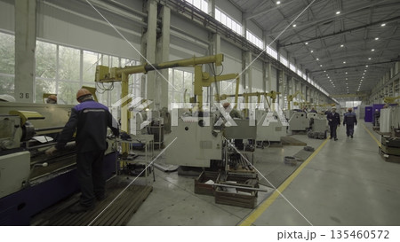 Industrial worker operating lathe machine in factory. Stock clip Industrial worker operating lathe machine in factory. Stock clip 135460572
