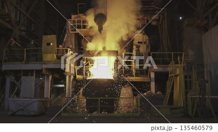 Molten metal pouring into a container in steel mill. Stock clip 135460579