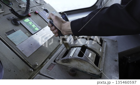 Captain operating levers on ship's bridge control panel. Clip 135460597