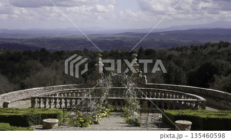 Wedding arch overlooking tuscan landscape at castello di velona resort. Action 135460598