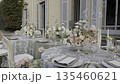 Elegant wedding reception table setting with floral centerpiece in a villa garden. Action 135460621