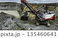 Excavator loading dump truck in open pit mine. Stock clip 135460641
