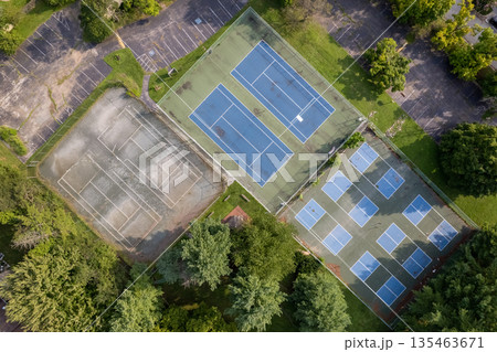 A tennis court with two courts, one of which is empty. Chesterbrook, USA A tennis court with two courts, one of which is empty. Chesterbrook, USA 135463671