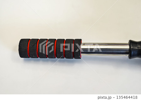 A close up view of a professional gray microfiber car duster featuring an ergonomic black and red foam handle, perfect for vehicle detailing, dust removal, and automotive maintenance A close up view of a professional gray microfiber car duster featuring an ergonomic black and red foam handle, perfect for vehicle detailing, dust removal, and automotive maintenance 135464418