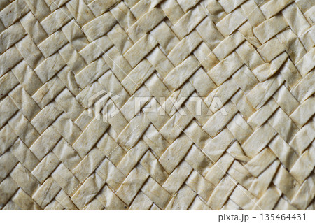 A detailed macro shot showing the intricate pattern and texture of a light beige natural woven material, perfect for backgrounds and organic designs A detailed macro shot showing the intricate pattern and texture of a light beige natural woven material, perfect for backgrounds and organic designs 135464431