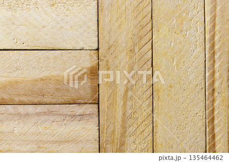 Macro shot featuring the natural texture and grain of light-colored wooden planks arranged in vertical and horizontal patterns. Ideal for rustic or carpentry design themes Macro shot featuring the natural texture and grain of light-colored wooden planks arranged in vertical and horizontal patterns. Ideal for rustic or carpentry design themes 135464462