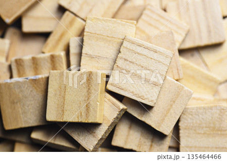 Close-up top view of natural light wooden blocks arranged in a pattern, highlighting the organic wood grain texture. Ideal for educational, architectural, or minimalist design backgrounds 135464466