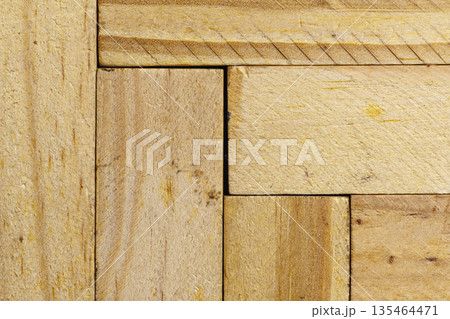Macro shot featuring the natural texture and grain of light-colored wooden planks arranged in vertical and horizontal patterns. Ideal for rustic or carpentry design themes Macro shot featuring the natural texture and grain of light-colored wooden planks arranged in vertical and horizontal patterns. Ideal for rustic or carpentry design themes 135464471