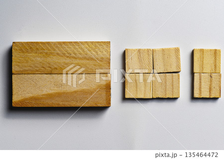 Close-up of natural wooden blocks in various sizes and shapes, neatly arranged on a white textured surface. Ideal for education, building, or minimalist design concepts Close-up of natural wooden blocks in various sizes and shapes, neatly arranged on a white textured surface. Ideal for education, building, or minimalist design concepts 135464472