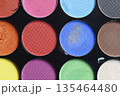 Macro shot of a professional makeup palette featuring various bright and matte eyeshadow shades. Perfect for beauty, fashion, and cosmetic themes 135464480
