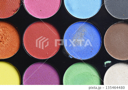 Macro shot of a professional makeup palette featuring various bright and matte eyeshadow shades. Perfect for beauty, fashion, and cosmetic themes Macro shot of a professional makeup palette featuring various bright and matte eyeshadow shades. Perfect for beauty, fashion, and cosmetic themes 135464480