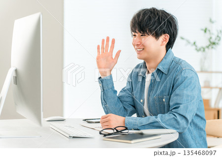 デスクトップパソコンでオンライン会議,リモート会議をする若いアジア人男性 デスクトップパソコンでオンライン会議,リモート会議をする若いアジア人男性 135468097