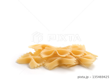 Italian dry farfalle pasta over white background with shadow top view 135469425