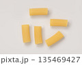 Italian dry rigatoni pasta over white background with shadow top view 135469427